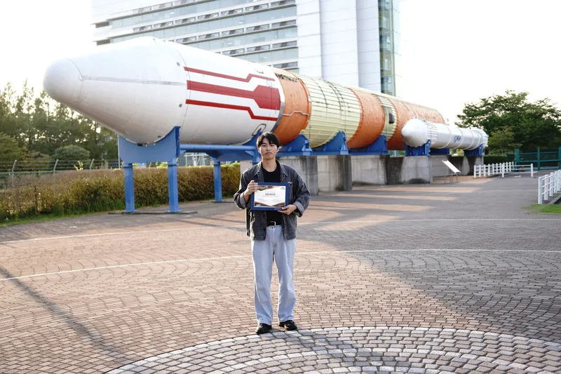 Group photo in front of the H-II rocket at Tsukuba Space Center